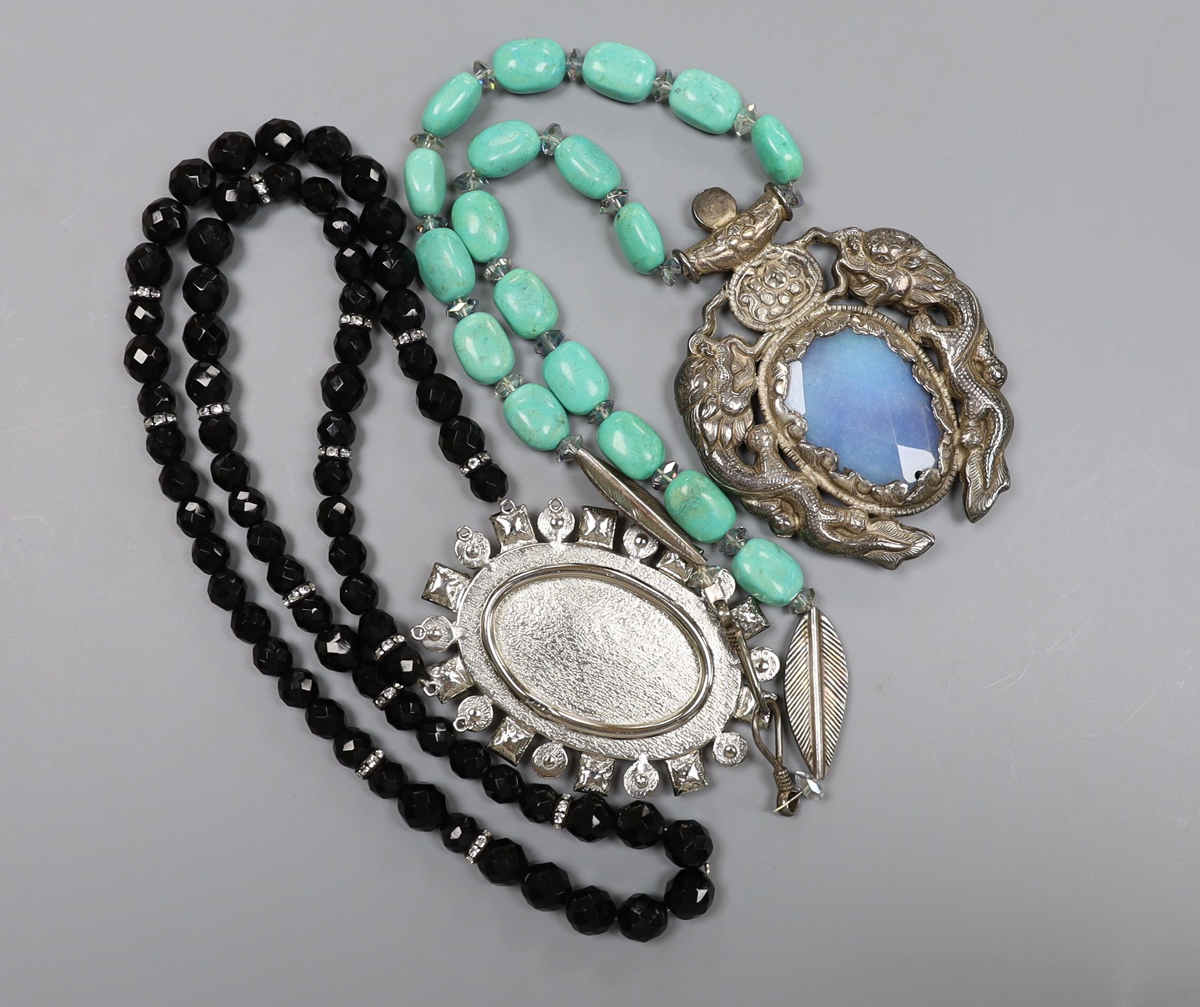 A large 20th century continental white metal, blue quartz and turquoise set drop necklace, 76cm and one other costume necklace.